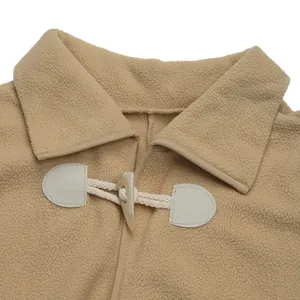 Detail of soft fleece jacket featuring classic lapel and resin toggle button closure