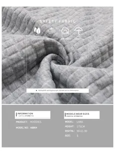 Detailed macro view of gray waffle knit fabric texture on a long sleeve women sweatshirt