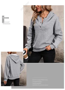 Detail of grey waffle knit hoodie featuring buttoned Henley collar and textured fabric