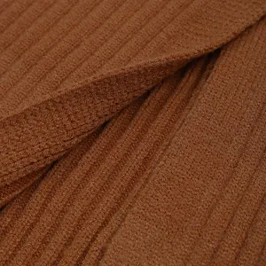 Macro shot of dark caramel ribbed knit fabric showing texture and vertical striped pattern