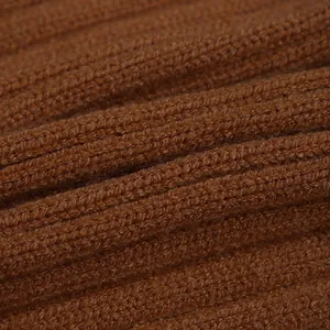 Macro shot of brown ribbed knit fabric showing thick texture and soft wool blend fibers
