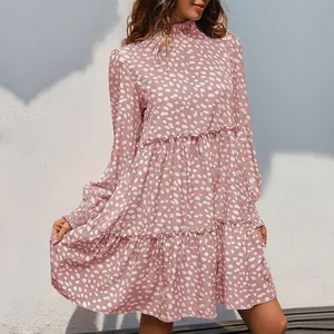 Detail of pink polka dot tiered dress with ruffle neckline and long sleeves
