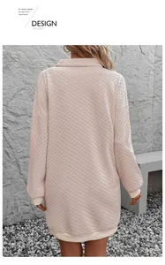 Detail of pink diamond-quilted sweatshirt dress featuring ribbed cuffs and a polo collar