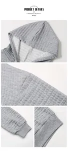 Detail of grey waffle knit hoodie showing quilted texture, hood seams and ribbed cuffs