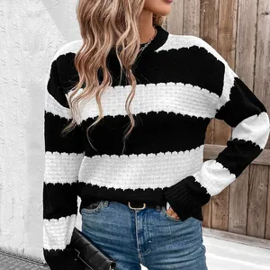 Close-up of crew neck knit sweater featuring bold black and white stripes and textured crochet