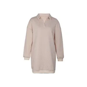 Detail of light pink quilted dress showing V-neck polo collar and diamond stitch texture