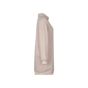 Detail of light pink quilted long-sleeve top showing diamond texture and ribbed cuffs