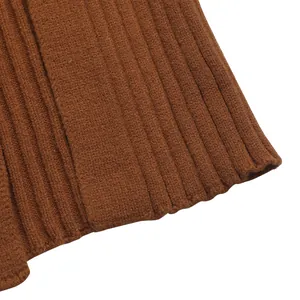 Detailed macro view of the ribbed knit texture and stitching on a caramel bodycon skirt