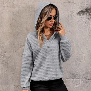 Women's grey quilted waffle knit hoodie with buttoned neckline and relaxed casual fit