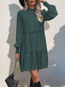 Detail of smocked honeycomb cuffs on leopard print long sleeve tiered midi dress