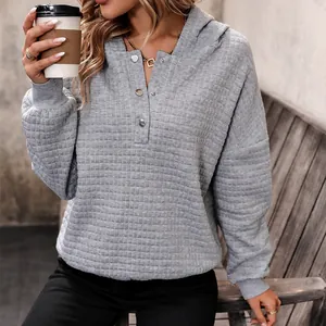Women's grey waffle knit hoodie with Henley neck and metal buttons in a loose fit style