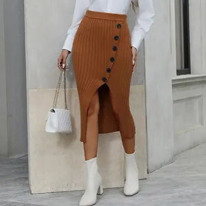 Detail of caramel knit skirt featuring vertical ribs and elegant side buttons with a split