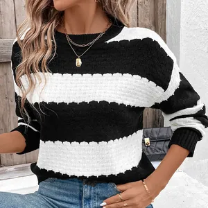 Close-up of black and white striped knit texture and round neckline details on sweater