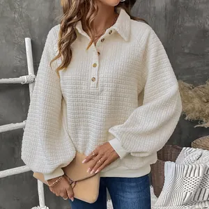 Detail of white waffle texture fabric on a button-up pullover with chic lantern sleeves