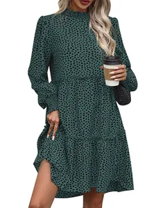 Detail of dark green leopard print tiered dress with ruffled hem and elastic cuffs