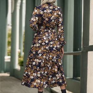 Back view of elegant long sleeve floral dress with waist tie and ruffled hem details