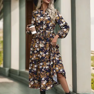 Detailed close-up of the vintage floral pattern and layered hem on long sleeve dress