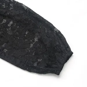 Detail of delicate black lace sleeve with floral patterns and elasticated cuffs