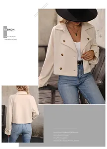 Detail of cream double-breasted cropped coat with notched lapels and amber buttons