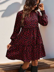 Detail of high neck leopard print dress with long elastic cuffs and tiered skirt