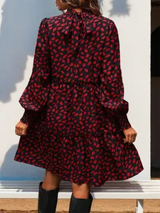 Detail of floral print tiered dress with leopard accents, high neck tie and elastic cuffs