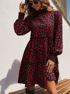 Detailed close-up of smocked cuffs and leopard print pattern on long sleeve dress