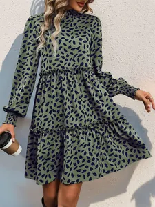 Detail of sage green long sleeve floral dress with tiered ruffled skirt and elastic cuffs