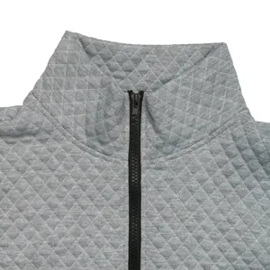 Close-up of grey waffle texture fabric and half-zip collar on a casual sweatshirt