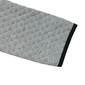Detail of grey waffle knit pullover with diamond quilting and black piped edges