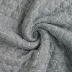Close-up detail of grey waffle texture fabric with quilted diamond pattern design