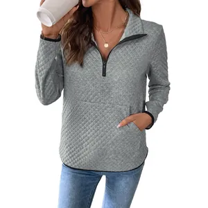 Women's grey waffle knit quarter-zip sweatshirt with textured fabric and kangaroo pocket