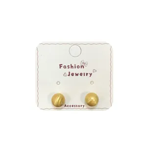Minimalist matte gold flower ball stud earrings for women on a white display card