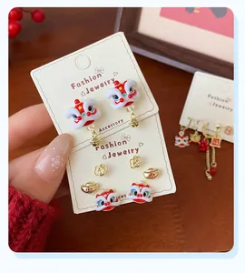Detailed view of Chinese New Year earrings featuring lucky lion and festive bell charms
