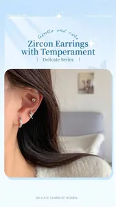 Detailed view of silver hoop earrings with zircon stones worn on the earlobe and cartilage