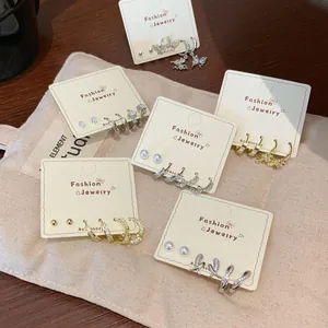 Mixed set of gold and silver cross butterfly earrings with zircon and pearl accents