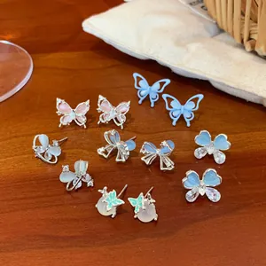 Elegant butterfly and opal stud earring collection in silver, pink, and mint green