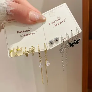 Golden and silver hoop earring set with rabbit, heart, and black butterfly designs