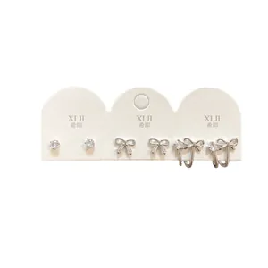 Three-piece silver stud earring set featuring zircon bows and minimalist round stones
