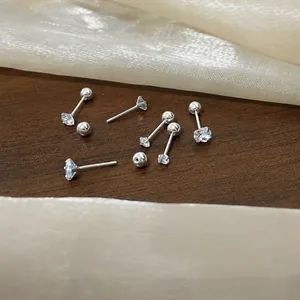 Detail of zircon stud earrings with screw back design for secure sleeping comfort