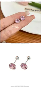 Macro view of 7mm pink zircon stud earrings with silver four-claw setting and screw back