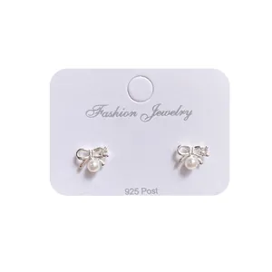 Elegant 925 silver bow stud earrings with white pearls and sparkling accents