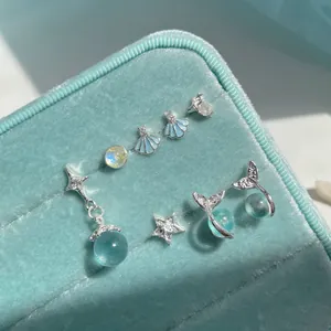 Set di orecchini a tema marino con stella marina, conchiglia e coda di sirena in blu