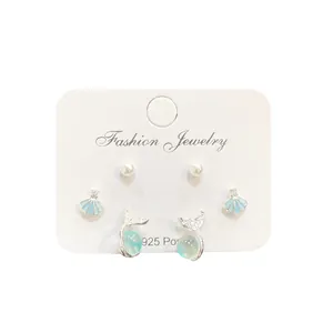 Set orecchini tema oceano con perni in argento, conchiglie e code di pesce