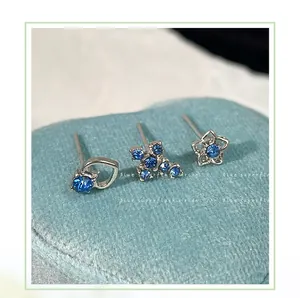Macro di orecchini in argento con zircone blu in forme di cuore stella e croce