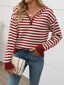 Detail of red and white striped knit hoodie with metal half-zip and gold necklaces