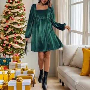 Elegant dark green velvet square neck long sleeve Christmas dress in festive indoor setting