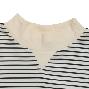 Detail of classic black and white striped long sleeve shirt with beige ribbed crew neckline