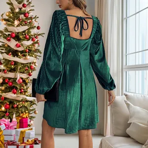 Elegant green velvet square neck dress with puff sleeves and back bow on Christmas backdrop