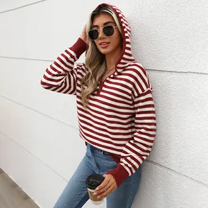 Detail of red and white striped hoodie with half-zipper and soft ribbed cuffs