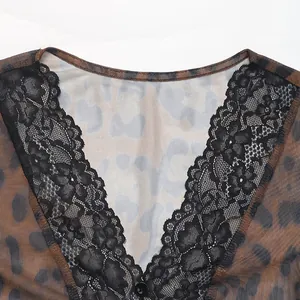 Close-up of leopard print mesh fabric with V-neckline and delicate black lace trim detailing